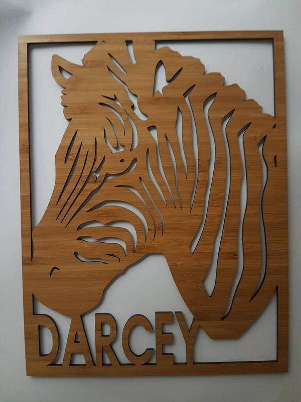 Cut-out bamboo zebra head sign with the name Darcey