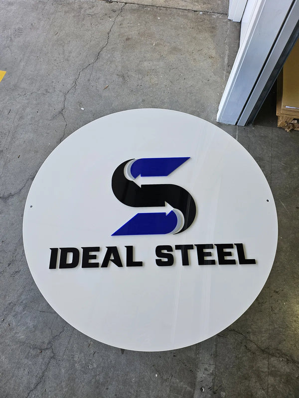 Round white Ideal Steel sign with a blue and black logo
