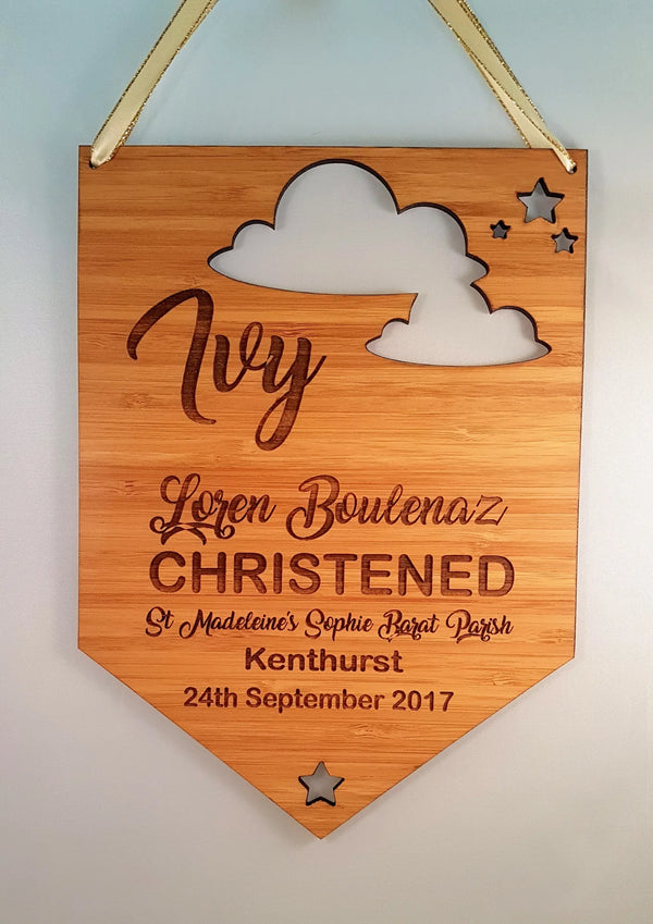 Bamboo christening pennant for Ivy with a cloud and stars cut-out and engraved details