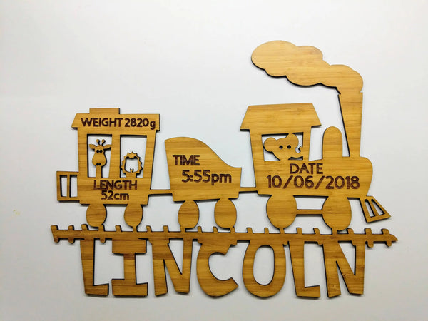 Cut-out bamboo train birth announcement sign for Lincoln with weight, length, time and date