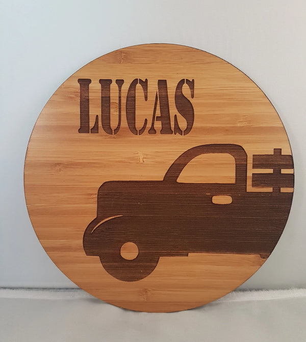 Round bamboo name plaque reading Lucas with an engraved vintage truck