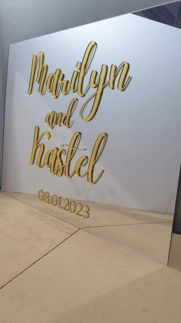 Large white acrylic panel with gold 3D lettering reading Marilyn and Kastel