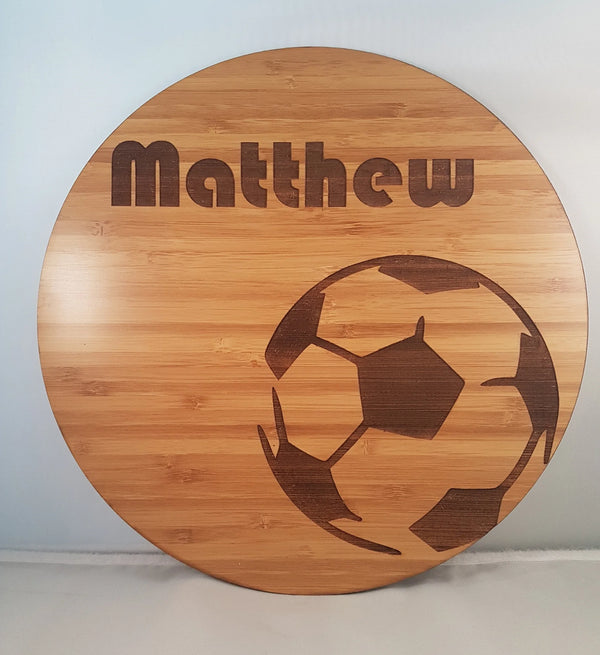 Round bamboo name plaque reading Matthew with an engraved soccer ball