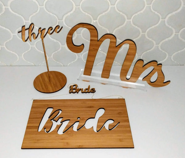 Bamboo wedding set with cut-out Mrs lettering, a Bride sign and a number stand