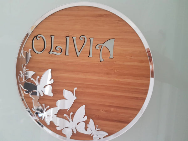 Round bamboo plaque reading Olivia with mirror acrylic butterflies
