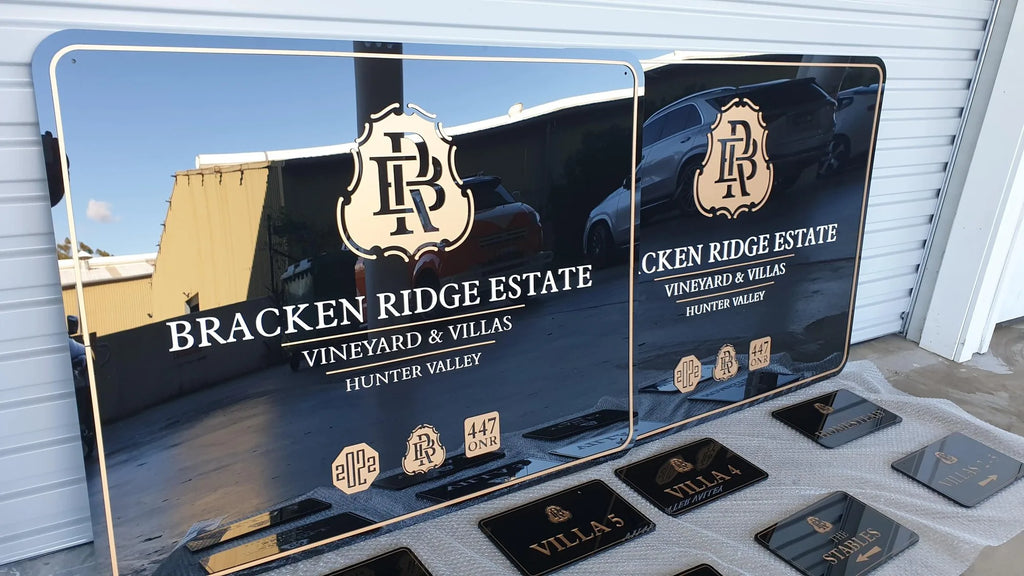 Black mirror acrylic Bracken Ridge Estate Vineyard and Villas signs with gold crest