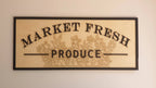 Framed timber Market Fresh Produce sign with black raised lettering and engraved flowers