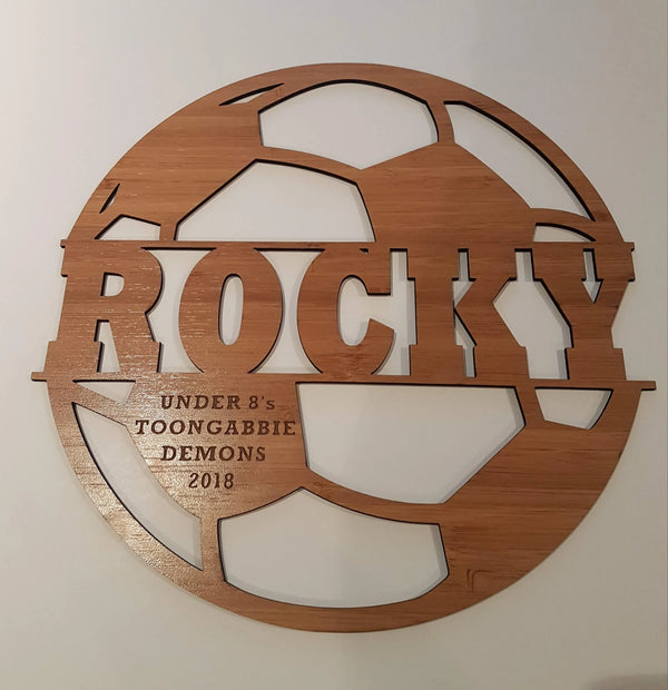 Cut-out bamboo soccer ball sign reading Rocky, Under 8s Toongabbie Demons 2018