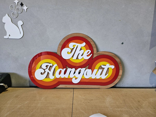 Retro red, orange and yellow The Hangout sign with white lettering