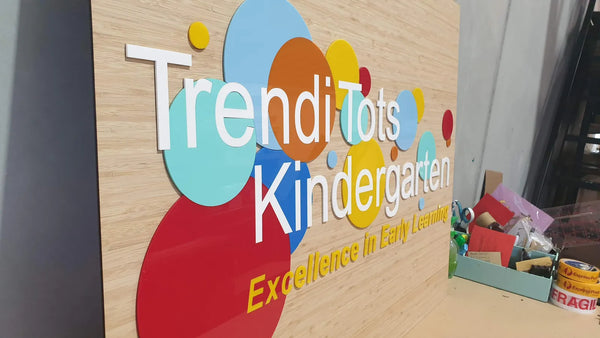 Colourful 3D acrylic dots and lettering on a timber wall for Trendi Tots Kindergarten